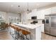 Modern kitchen featuring an island with seating and stainless steel appliances at 1154 Romeria Dr, Durham, NC 27713