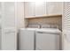 Efficient laundry room with a washer, dryer, and overhead cabinets for organized storage at 1154 Romeria Dr, Durham, NC 27713