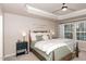 A serene main bedroom with a tray ceiling, natural light, and calming decor at 1154 Romeria Dr, Durham, NC 27713