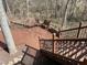 Elevated back deck with stairs features two benches overlooking a wooded backyard at 118 N Drawbridge Ln, Cary, NC 27513