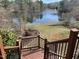 Back deck with stairs overlooking a backyard pond at 118 N Drawbridge Ln, Cary, NC 27513