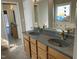 Bathroom featuring a double sink vanity and custom stained glass window at 118 N Drawbridge Ln, Cary, NC 27513