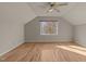 Bright bedroom with a ceiling fan and a large window, hardwood floors, and neutral paint colors at 118 N Drawbridge Ln, Cary, NC 27513