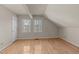 Charming bedroom with two windows, hardwood floors, and attic ceiling at 118 N Drawbridge Ln, Cary, NC 27513