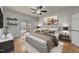 Bedroom with a ceiling fan, sliding glass doors to a porch, and an abstract art piece at 118 N Drawbridge Ln, Cary, NC 27513
