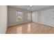 Bright bedroom with hardwood floors, a ceiling fan, and two windows at 118 N Drawbridge Ln, Cary, NC 27513