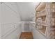 View of a walk-in closet with hardwood floors and wire shelving units at 118 N Drawbridge Ln, Cary, NC 27513
