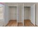 Triple closets with white doors and wire shelves, ready for ample storage in the bedroom at 118 N Drawbridge Ln, Cary, NC 27513