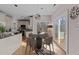 Dining area next to the kitchen with round table, stylish light fixture, and sliding door at 118 N Drawbridge Ln, Cary, NC 27513