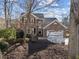 Brick two-story home featuring well-maintained landscaping under a partly cloudy sky at 118 N Drawbridge Ln, Cary, NC 27513