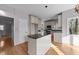 Kitchen island features granite countertops, custom cabinetry, and stainless steel appliances at 118 N Drawbridge Ln, Cary, NC 27513