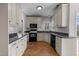 Traditional kitchen with stainless steel appliances, granite countertops, and herringbone wood floor at 118 N Drawbridge Ln, Cary, NC 27513
