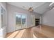 Living room featuring hardwood floors, a fireplace, and sliding glass door access to a deck at 118 N Drawbridge Ln, Cary, NC 27513