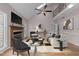 Modern living room features a fireplace, ample seating, and an open staircase at 118 N Drawbridge Ln, Cary, NC 27513
