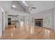 Open-concept space with wood floors, fireplace, vaulted ceiling, and seamless kitchen access at 118 N Drawbridge Ln, Cary, NC 27513