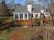 Rear exterior of house featuring a back deck and sunroom at 118 N Drawbridge Ln, Cary, NC 27513