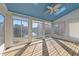 Bright sunroom with a skylight, ceiling fan, and panoramic views of the lake at 118 N Drawbridge Ln, Cary, NC 27513