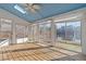 Sunroom showcasing multiple windows and skylight with wooden floors overlooking the lake at 118 N Drawbridge Ln, Cary, NC 27513