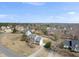 Overview of the neighborhood, highlighting a two-story home with well-maintained landscaping and mature trees at 126 Claire Dr, Clayton, NC 27520