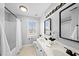 Bright bathroom featuring double vanity, stylish mirrors and updated fixtures at 126 Claire Dr, Clayton, NC 27520