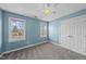 Cozy bedroom featuring plush carpet, ample natural light, and a ceiling fan at 126 Claire Dr, Clayton, NC 27520