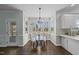 Bright breakfast nook featuring a glass table, hardwood floors, and expansive windows at 126 Claire Dr, Clayton, NC 27520