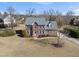Charming brick two-story home with a well-manicured lawn, beautiful landscaping, and mature trees at 126 Claire Dr, Clayton, NC 27520