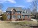 Charming brick two-story home with manicured lawn and blue shutters exudes curb appeal at 126 Claire Dr, Clayton, NC 27520