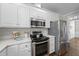 Bright kitchen featuring stainless steel appliances, white cabinets, and stone countertops at 126 Claire Dr, Clayton, NC 27520