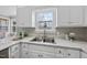Bright kitchen showcasing a stainless steel sink, white cabinets, and stone countertops at 126 Claire Dr, Clayton, NC 27520