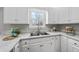 Bright kitchen showcasing a stainless steel sink, white cabinets, and stone countertops at 126 Claire Dr, Clayton, NC 27520