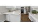 Bright kitchen featuring stainless steel appliances, white cabinets, and stone countertops at 126 Claire Dr, Clayton, NC 27520