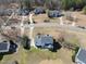 Aerial shot of a white two-story home, showcasing back yard, with mature trees, and a charming screened porch at 126 Claire Dr, Clayton, NC 27520