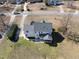 Aerial view of a white two-story home with well maintained lawn, showcasing rear patio and mature trees at 126 Claire Dr, Clayton, NC 27520