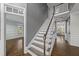 Elegant staircase with wood handrail, white risers, and views into other rooms at 126 Claire Dr, Clayton, NC 27520