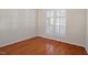 Serene bedroom features hardwood floors, natural light, and ample space at 1324 Vanagrif Ct, Wake Forest, NC 27587
