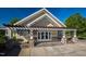 A charming single-story building with a decorative pergola and stone accents, offering a welcoming and stylish entrance at 1324 Vanagrif Ct, Wake Forest, NC 27587