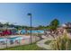 Resort-style community pool with ample seating, a slide, and well-maintained landscaping, perfect for relaxation at 1324 Vanagrif Ct, Wake Forest, NC 27587