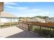 Exterior view of the backyard deck with wood railing and neighborhood view at 1324 Vanagrif Ct, Wake Forest, NC 27587