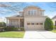 Charming two-story home with brick facade, attached garage and manicured landscaping, perfect for suburban living at 1324 Vanagrif Ct, Wake Forest, NC 27587