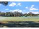 Beautiful golf course view with lush green fairways and a tranquil lake, perfect for a relaxing game at 1324 Vanagrif Ct, Wake Forest, NC 27587