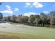 Golf course features lush green fairways, mature trees, and a tranquil pond at 1324 Vanagrif Ct, Wake Forest, NC 27587