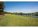 Scenic golf course with water feature, showcasing a lush green fairway and blue water view at 1324 Vanagrif Ct, Wake Forest, NC 27587