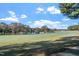 Golf course features lush green fairways, mature trees, and a tranquil pond at 1324 Vanagrif Ct, Wake Forest, NC 27587