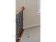 Upstairs hallway featuring neutral carpet and dark iron railing with wood banister at 1324 Vanagrif Ct, Wake Forest, NC 27587
