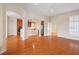 Spacious living room with hardwood floors, arched doorways, and abundant natural light at 1324 Vanagrif Ct, Wake Forest, NC 27587