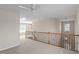 Bright open upstairs loft area featuring carpet flooring at 1324 Vanagrif Ct, Wake Forest, NC 27587