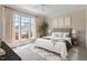 Serene main bedroom with large windows, plush carpet, neutral décor, and stylish furnishings for comfort at 1324 Vanagrif Ct, Wake Forest, NC 27587
