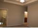 Spacious bedroom with neutral carpet, tray ceiling and views into bathroom and stairwell at 141 Rolesville Ridge Drive Dr, Rolesville, NC 27571