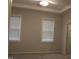 Bedroom featuring neutral carpet and gray walls with two windows providing light at 141 Rolesville Ridge Drive Dr, Rolesville, NC 27571